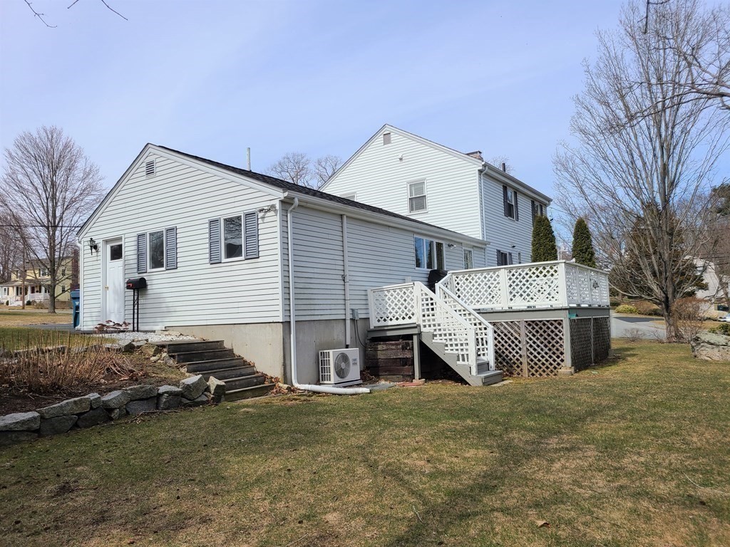 1 Lexington Circle Canton, MA 02021 - Photo 36 of 41 a front view of a house with a yard and garage