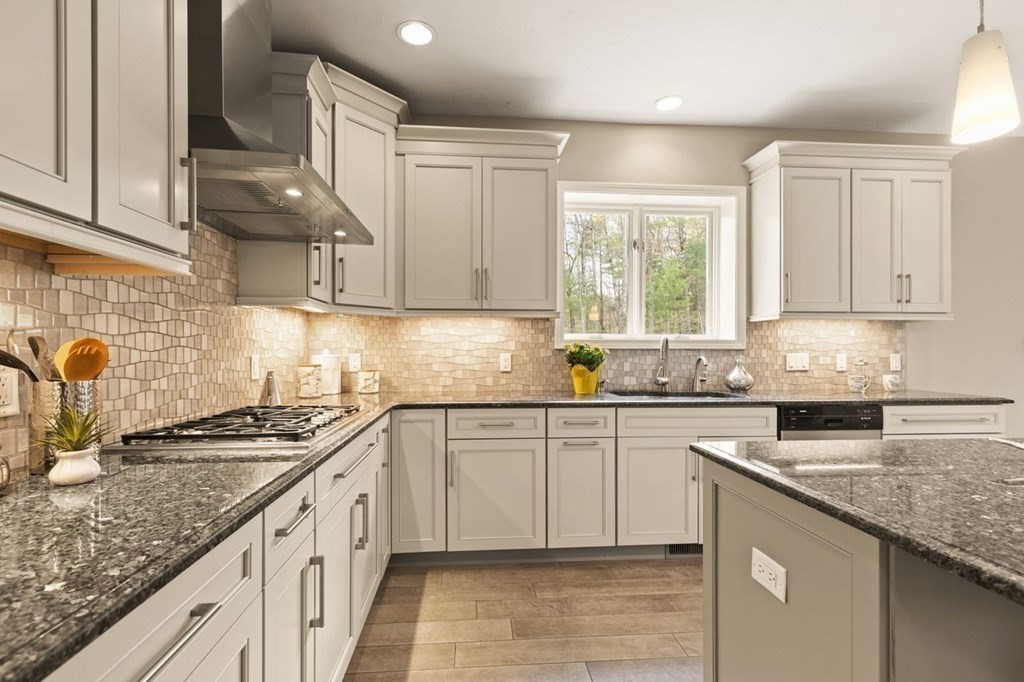 7 Wadsworth Way Sharon, MA 02067 - Photo 20 of 42 a kitchen with granite countertop a sink stove and cabinets