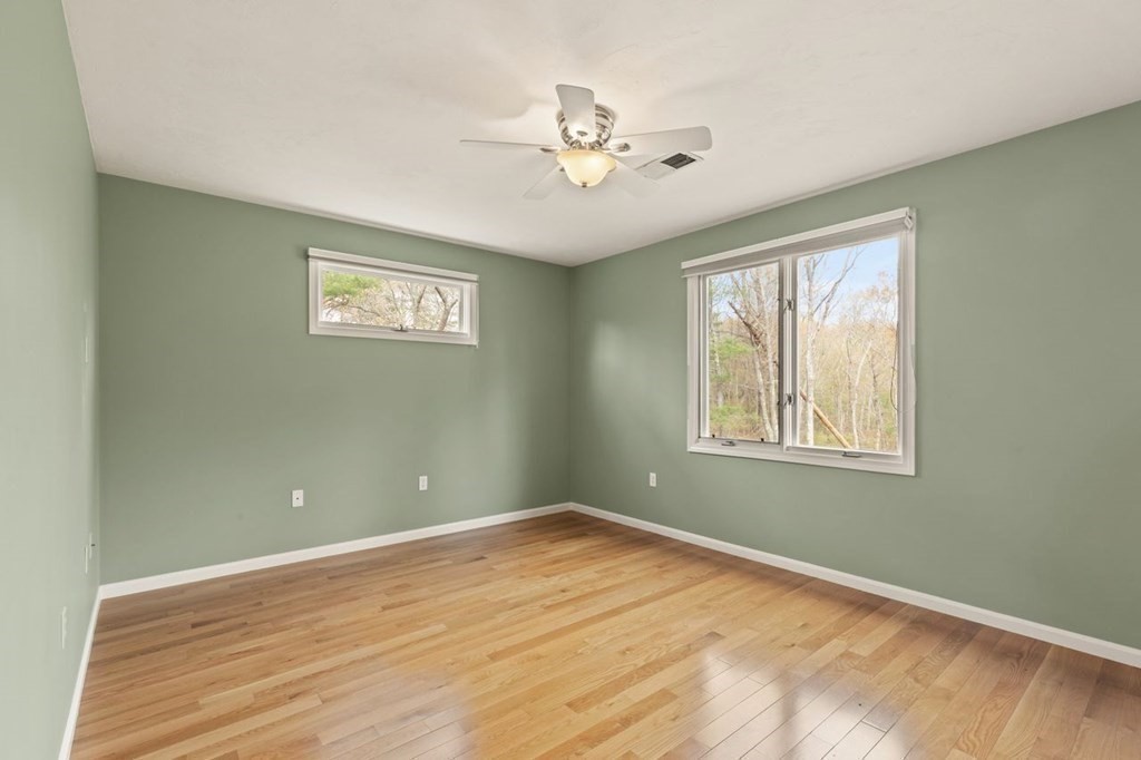 7 Wadsworth Way Sharon, MA 02067 - Photo 32 of 42 a view of an empty room with wooden floor and a window
