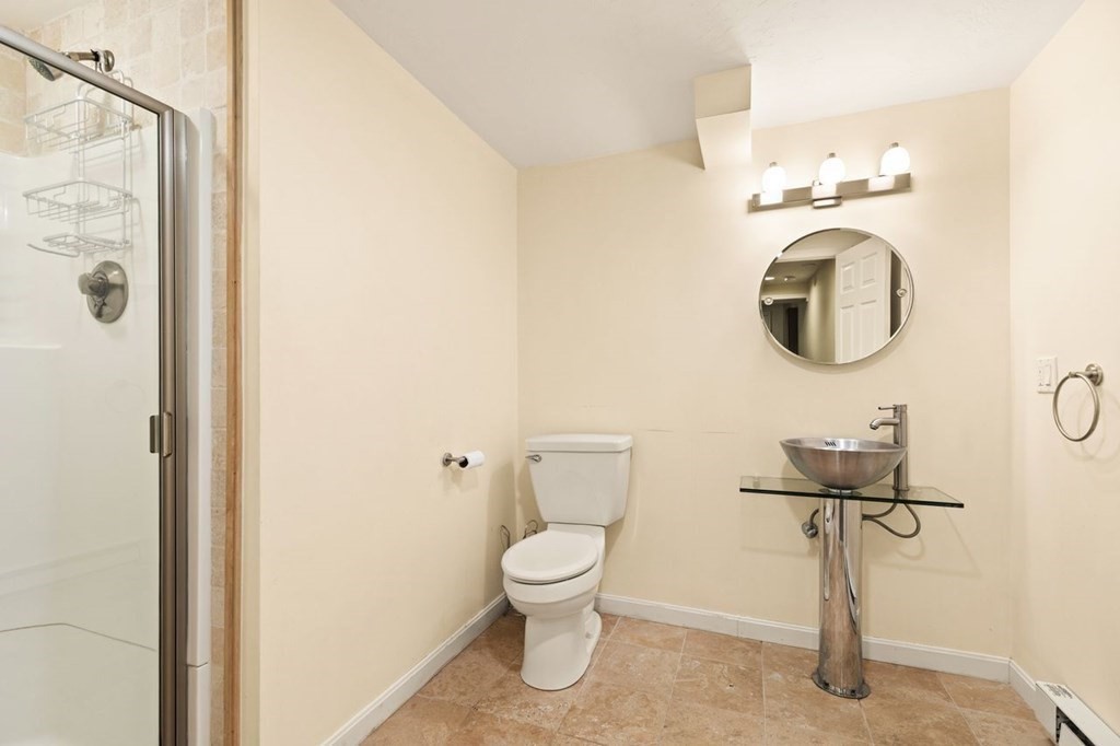 7 Wadsworth Way Sharon, MA 02067 - Photo 37 of 42 a bathroom with a toilet a sink and mirror