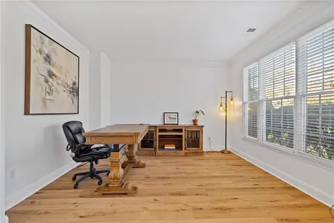 a large kitchen with stainless steel appliances granite countertop a sink dishwasher a stove and a refrigerator with wooden floor