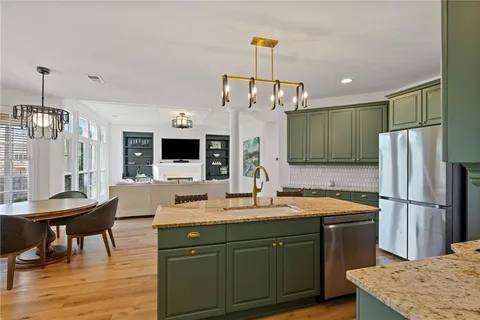 a spacious bedroom with a large bed and a chandelier
