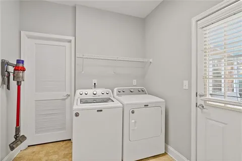 a spacious bathroom with a granite countertop double vanity sink a bathtub and shower