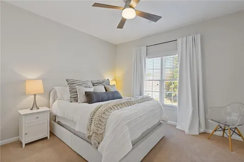 a bathroom with a granite countertop double vanity sink and a mirror