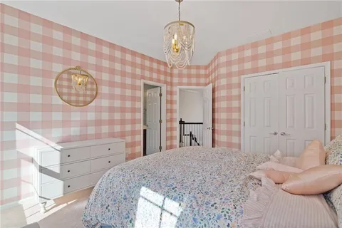 a spacious bedroom with a bed and a large window