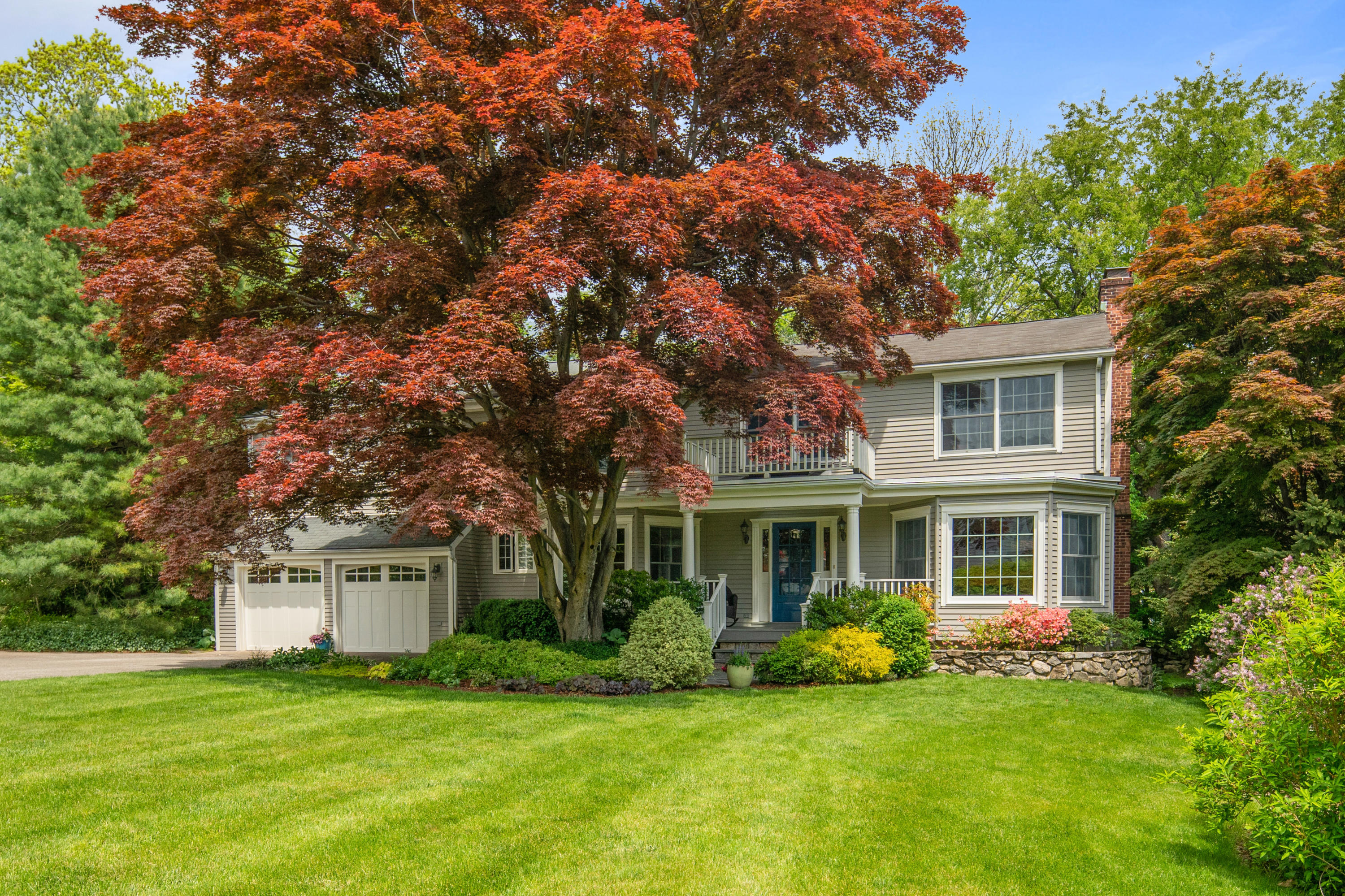 17 Wilson Ridge Road Darien, CT 06820 - Photo 1 of 37 a front view of a house with a garden and trees