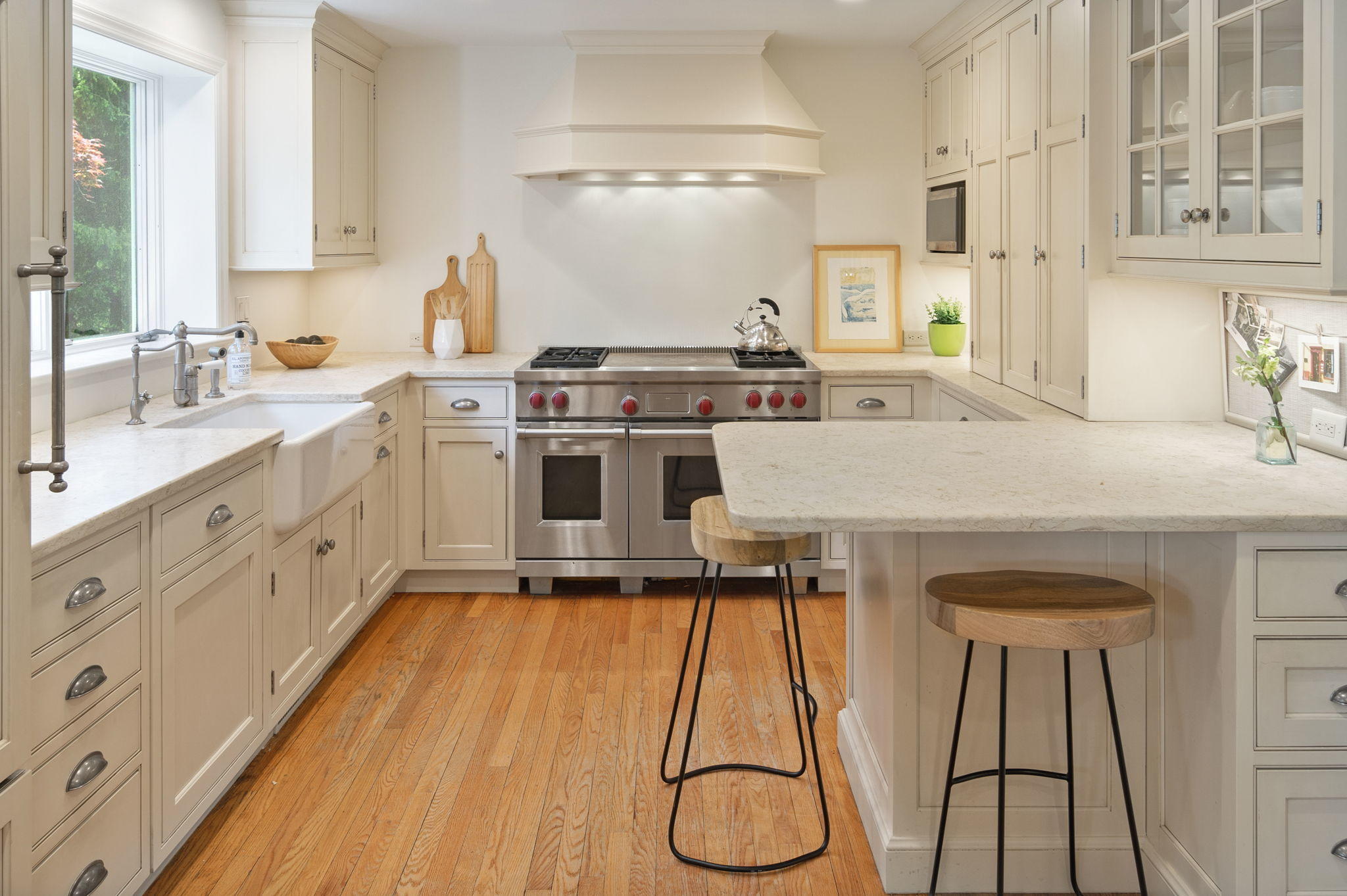 17 Wilson Ridge Road Darien, CT 06820 - Photo 12 of 37 a kitchen with stainless steel appliances a stove a sink and white cabinets with wooden floor