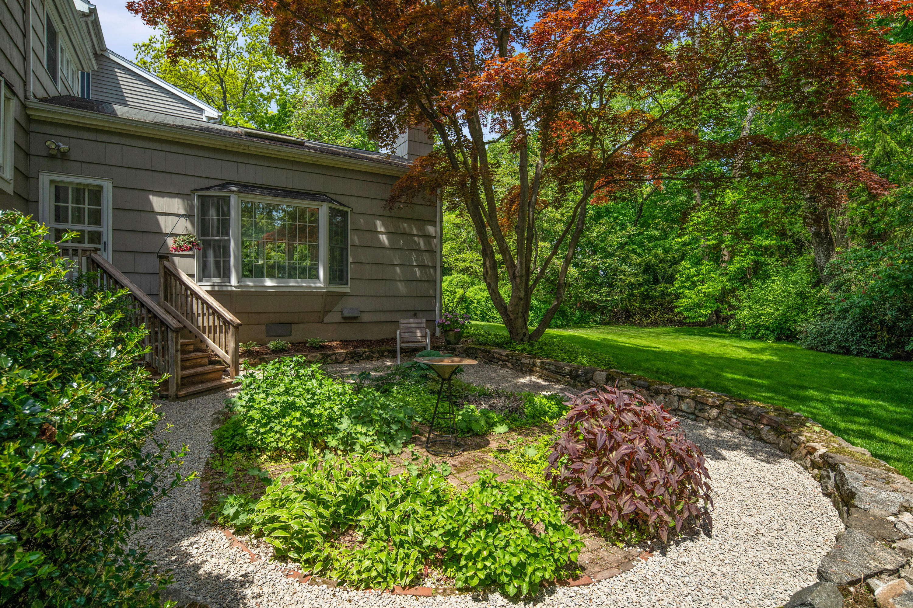 17 Wilson Ridge Road Darien, CT 06820 - Photo 36 of 37 a view of a backyard with potted plants and large tree