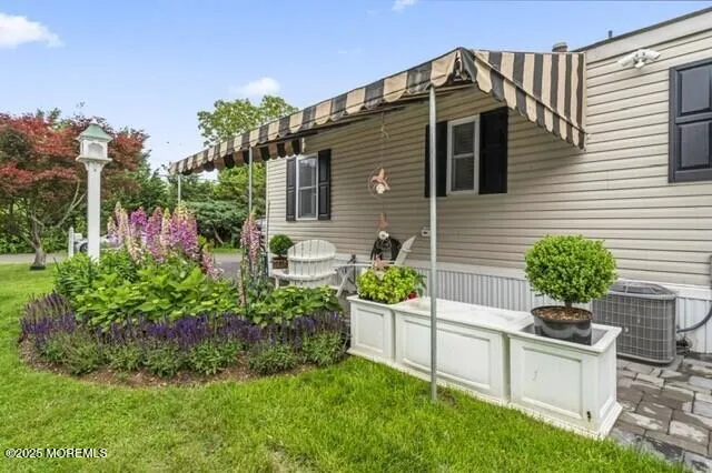 a front view of a house with a yard and potted plants