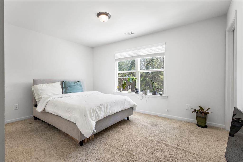 869 Venture Way Atlanta, GA 30331 - Photo 16 of 27 a large bed sitting in a room next to a window