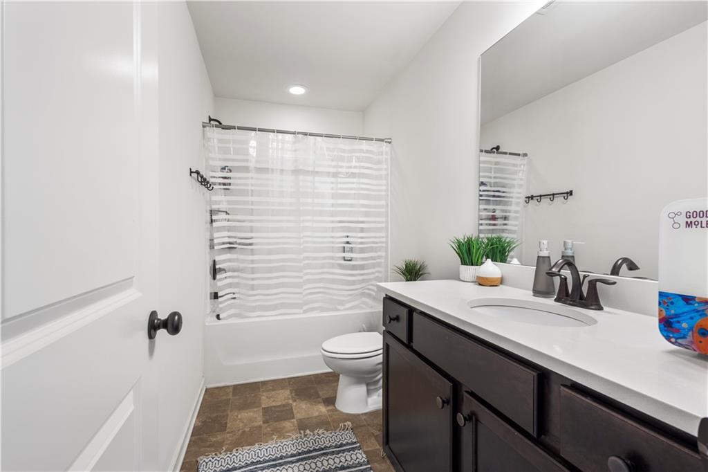 869 Venture Way Atlanta, GA 30331 - Photo 20 of 27 a bathroom with a sink a toilet a mirror and shower