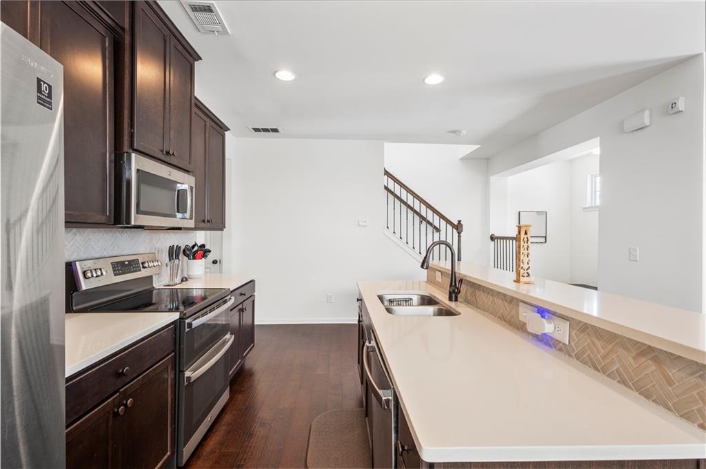 869 Venture Way Atlanta, GA 30331 - Photo 8 of 27 a kitchen with stainless steel appliances a stove sink microwave and cabinets
