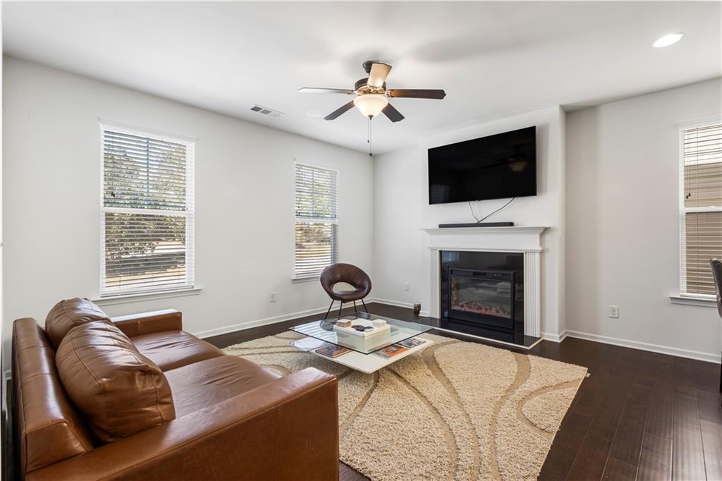869 Venture Way Atlanta, GA 30331 - Photo 10 of 27 a living room with furniture a flat screen tv and a fireplace