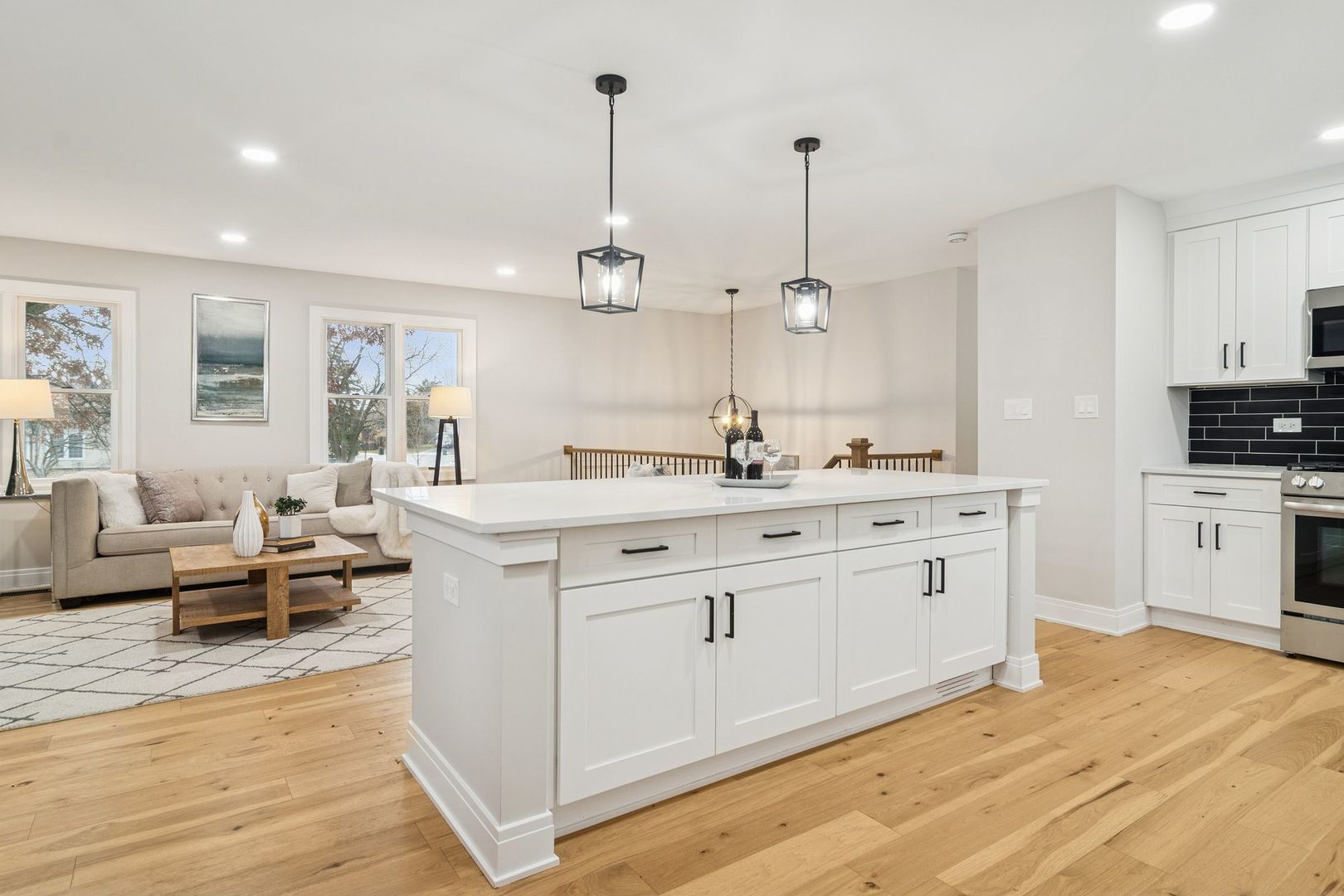 1420 Hassell Road Hoffman Estates, IL 60169 - Photo 11 of 26 a spacious bathroom with stainless steel appliances kitchen island granite countertop a sink dishwasher a stove and white cabinets with wooden floor
