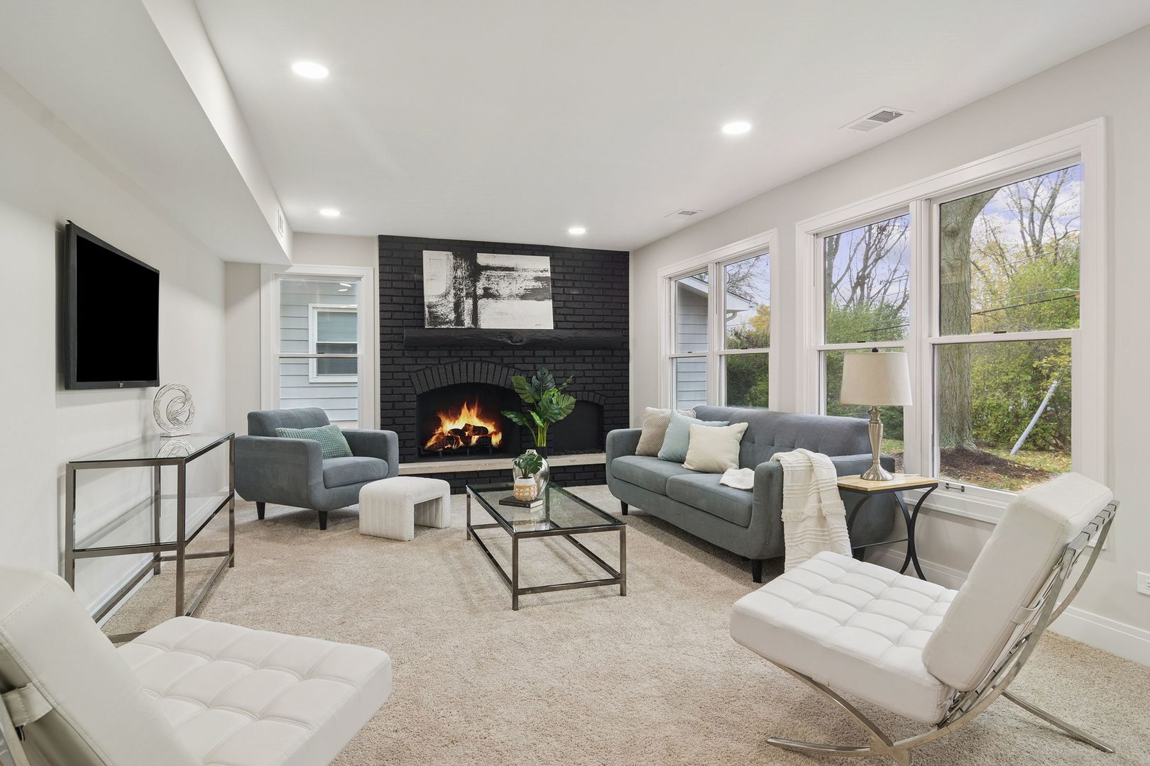 1420 Hassell Road Hoffman Estates, IL 60169 - Photo 18 of 26 a living room with furniture a flat screen tv and a fireplace