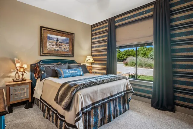 a bedroom with a bed next to a window