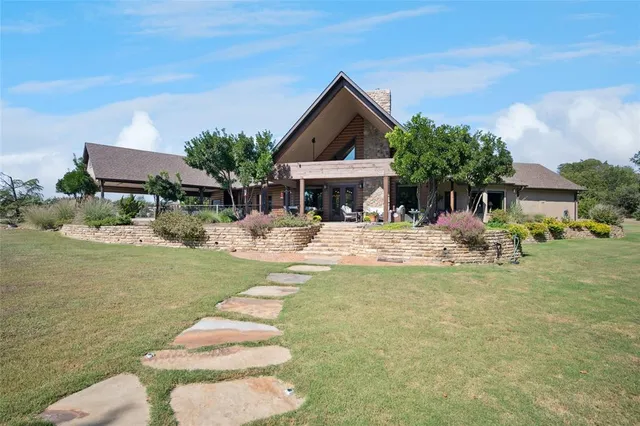 a front view of a house with swimming pool having outdoor seating