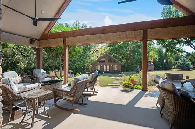 a view of a patio with a table chairs and a backyard