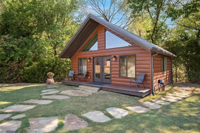 a front view of a house with a yard table and chairs