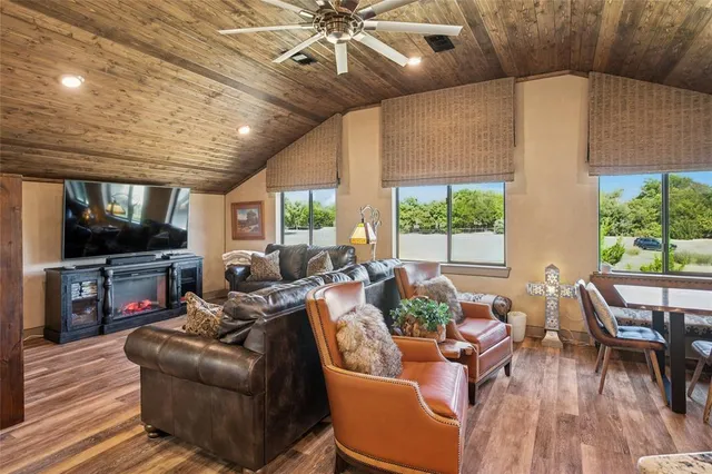 a open kitchen with stainless steel appliances granite countertop a stove refrigerator and a dining table with wooden floor