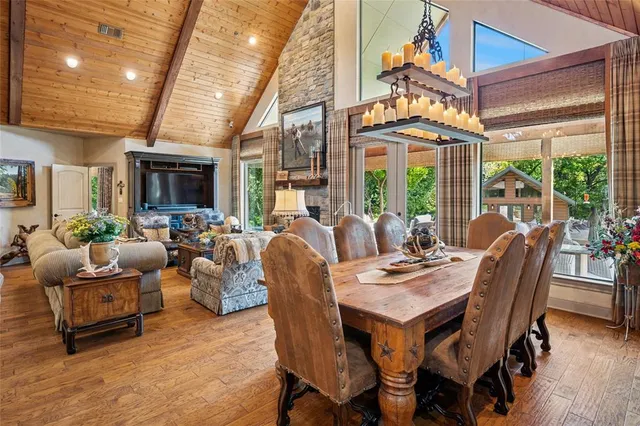 a view of a dining room with furniture a chandelier and wooden floor