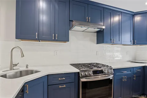 a kitchen with sink a stove and cabinets