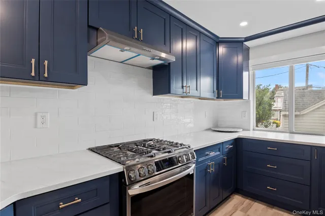 a kitchen with wooden cabinets and a stove top oven