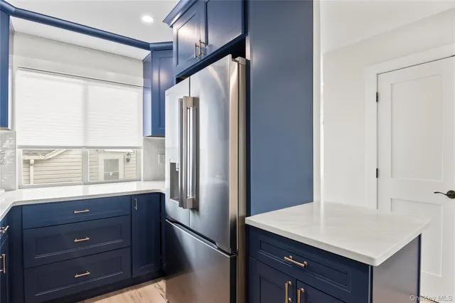 a kitchen with a refrigerator and a sink