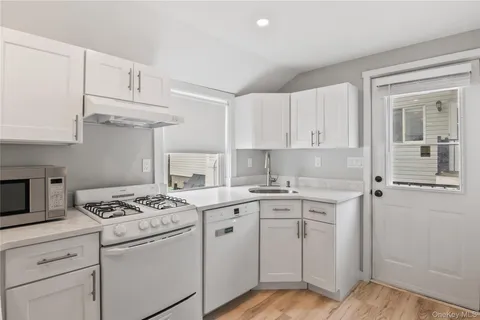 a kitchen with cabinets appliances a sink and a counter top space