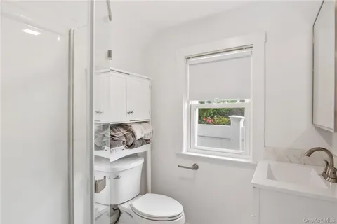 a white toilet sitting next to a bathroom sink