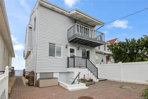 a view of a house with a wooden fence