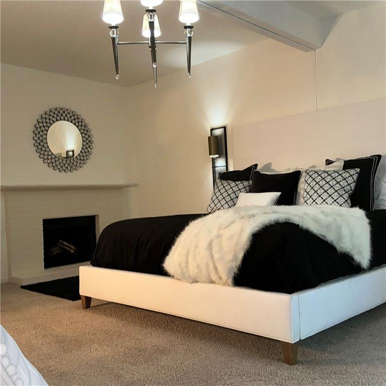 3823 Paces Ferry West Atlanta, GA 30339 - Photo 19 of 33 a bedroom with a bed and a fireplace