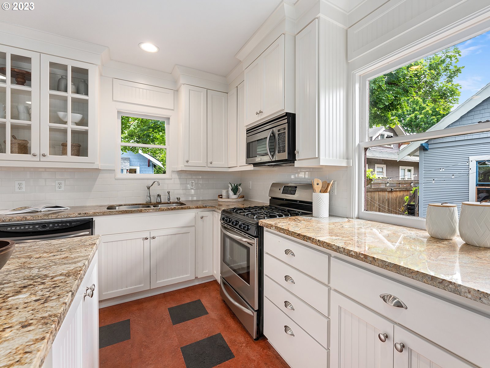 1920 Southeast 47th Avenue Portland, OR 97215 - Photo 14 of 40 a kitchen with granite countertop cabinets stainless steel appliances a sink and a large window