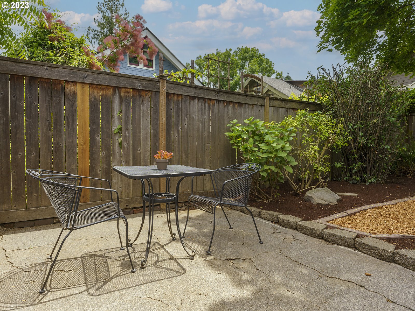 1920 Southeast 47th Avenue Portland, OR 97215 - Photo 35 of 40 a patio with table and chairs and potted plants