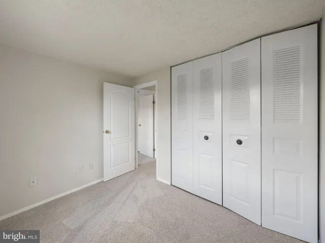 a view of a hallway with wooden floor and entryway
