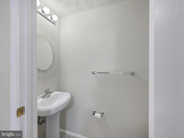 a bathroom with a granite countertop toilet and a sink