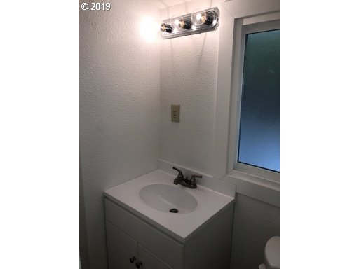 519 Southwest 14th Street Pendleton, OR 97801 - Photo 11 of 11 a bathroom with a sink a mirror and vanity