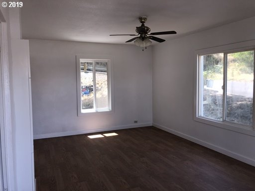 519 Southwest 14th Street Pendleton, OR 97801 - Photo 6 of 11 a view of an empty room with wooden floor and a window