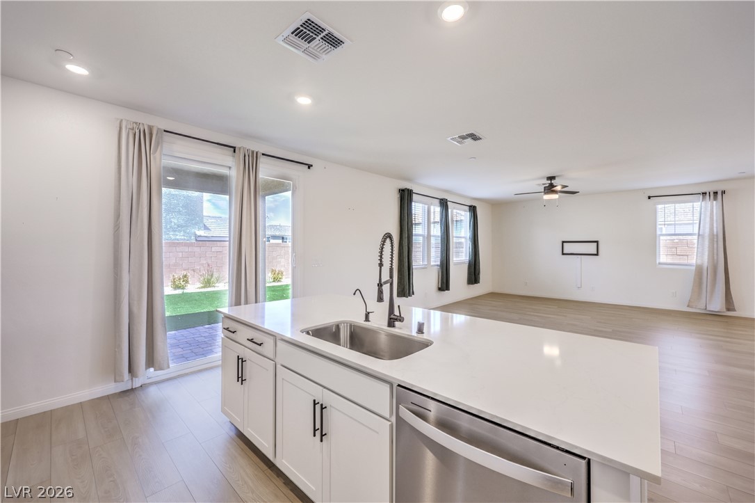 3782 Alla Rocca Avenue Henderson, NV 89044 - Photo 14 of 55 This bright, open concept living space offers a modern kitchen island and direct outdoor access.