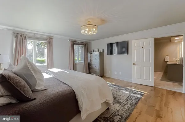a bedroom with a bed and a chandelier