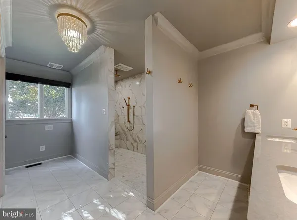a bathroom with a granite countertop double vanity sink and a mirror