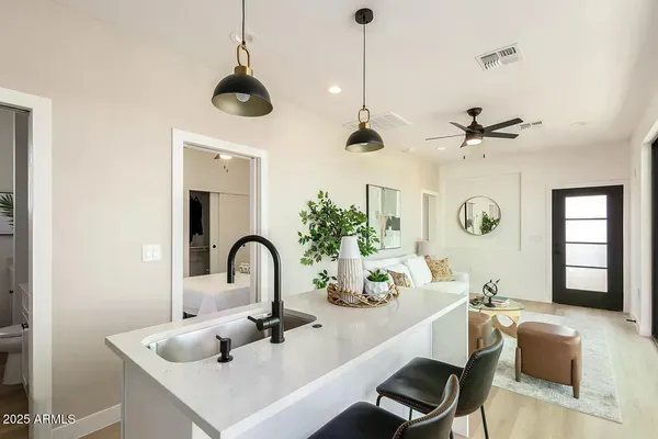 a kitchen with a sink a counter and cabinets