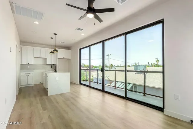 a large white kitchen with a large window