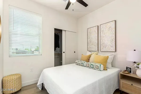 a bedroom with a bed and a window