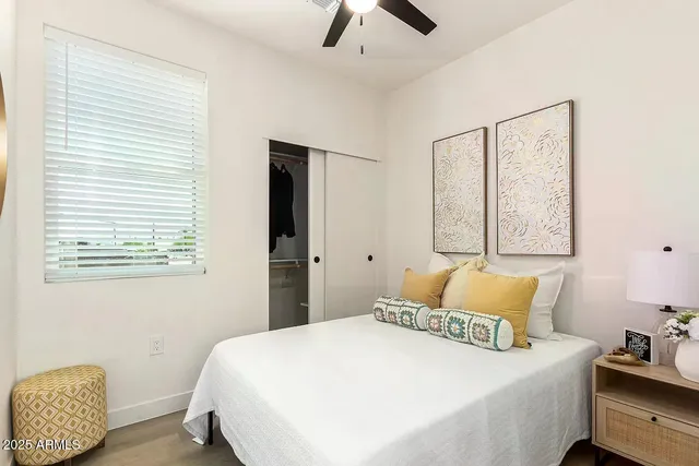 a bedroom with a bed and a window