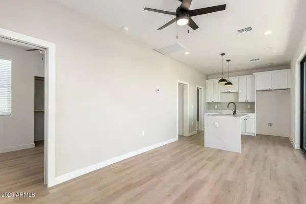 a view of a kitchen with a sink and dishwasher a refrigerator with wooden floor