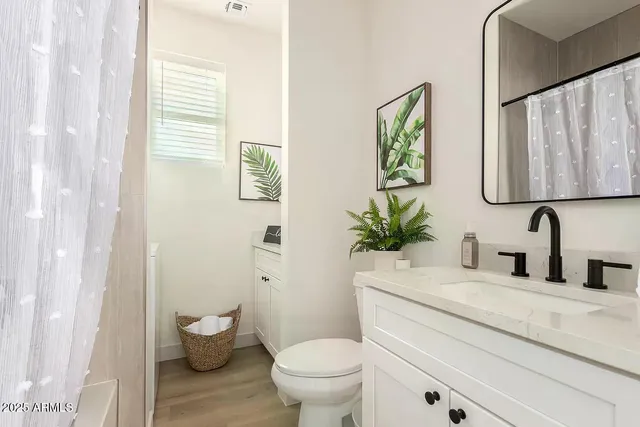 a bathroom with a toilet a sink and a window