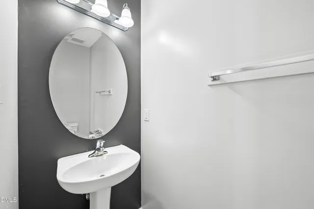 a bathroom with a sink and mirror