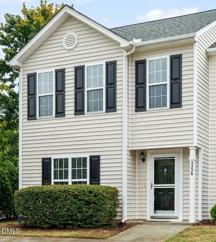 a view of a white house with large windows