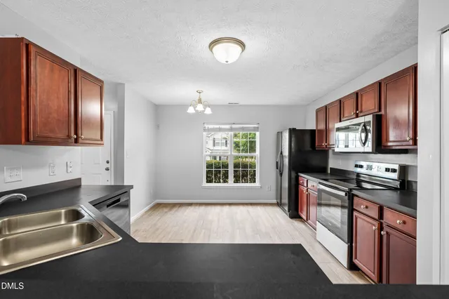 a kitchen with a sink stove and refrigerator